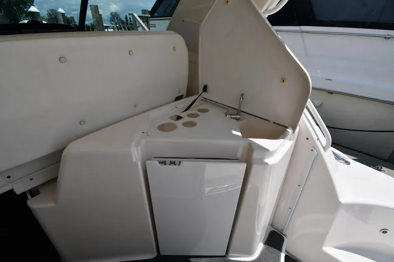 Slide: The Image of 2007 Tiara Yachts 4700 Sovran cockpit with built-in storage and cup holders. - 33