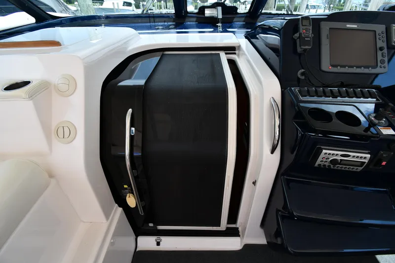 Slide: The Image of 2007 Tiara Yachts 4700 Sovran helm station with navigation equipment and cabin door. - 35