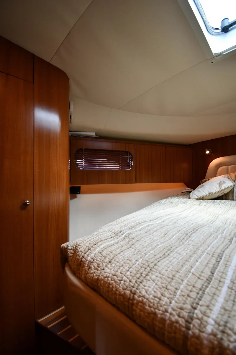 Slide: The Image of Luxurious bedroom interior of 2007 Tiara Yachts 4700 Sovran with wooden cabinetry. - 40