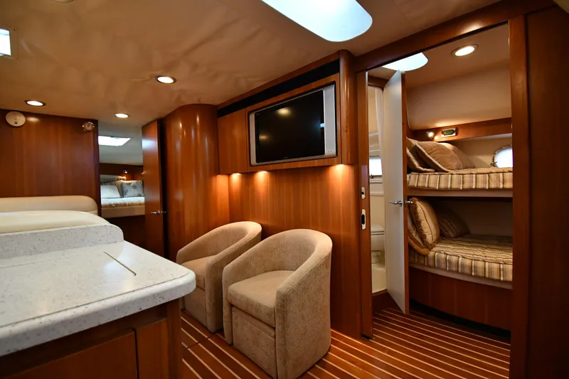 Slide: The Image of 2007 Tiara Yachts 4700 Sovran interior with seating, TV, and bunk beds. - 46