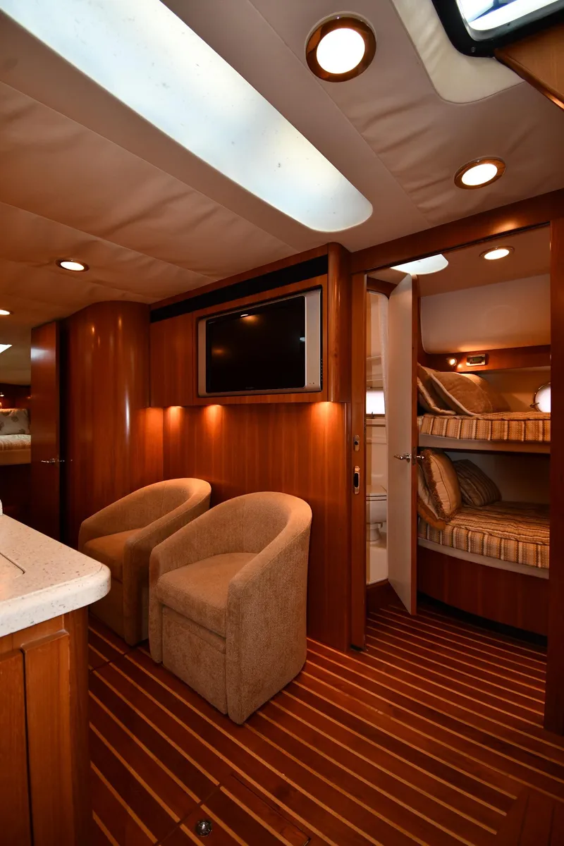 Slide: The Image of Interior of 2007 Tiara Yachts 4700 Sovran with cozy seating and bunk beds. - 47