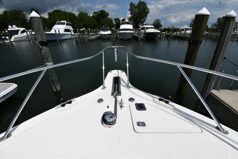 Slide: The Image of Bow view of a 2007 Tiara Yachts 4700 Sovran docked at a marina. - 5