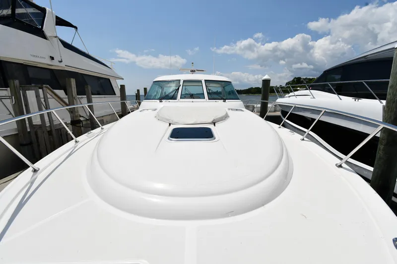 Slide: The Image of 2007 Tiara Yachts 4700 Sovran docked, front deck view under clear sky. - 7
