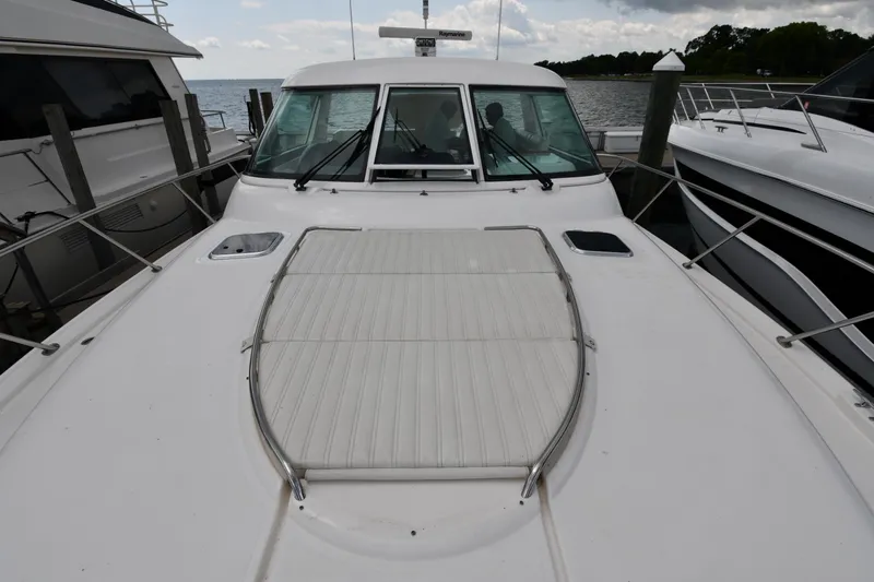 Slide: The Image of 2007 Tiara Yachts 4700 Sovran docked, front deck view with windshield and railings. - 9