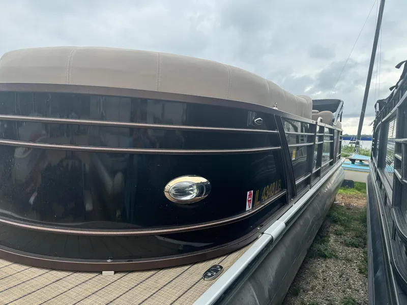 Slide: The Image of 2021 Veranda VTX25RC pontoon boat docked on a cloudy day. - 3