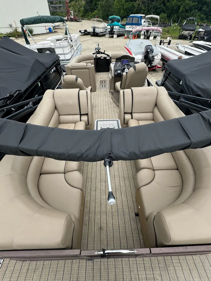 Slide: The Image of 2021 Veranda VTX25RC pontoon boat with beige seating at a marina. - 5