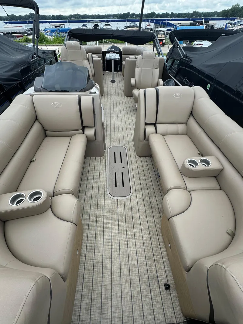 Slide: The Image of 2021 Veranda VTX25RC pontoon boat with spacious seating and cup holders, docked at a marina. - 7