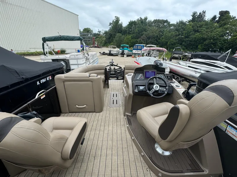 Slide: The Image of 2021 Veranda VTX25RC pontoon boat interior with beige seating and modern dashboard. - 9