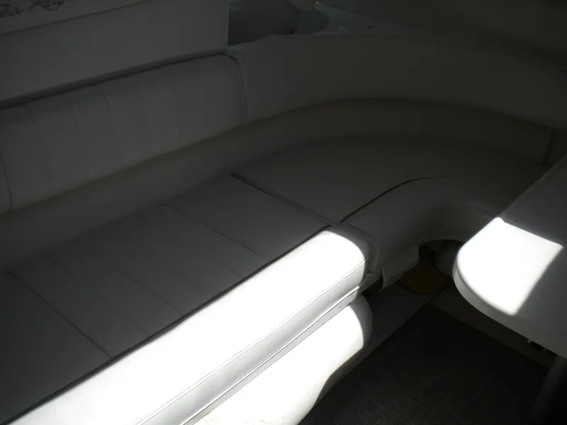 Slide: The Image of Interior seating of 1997 Sea Ray 400 Sundancer yacht, featuring white upholstery. - 22