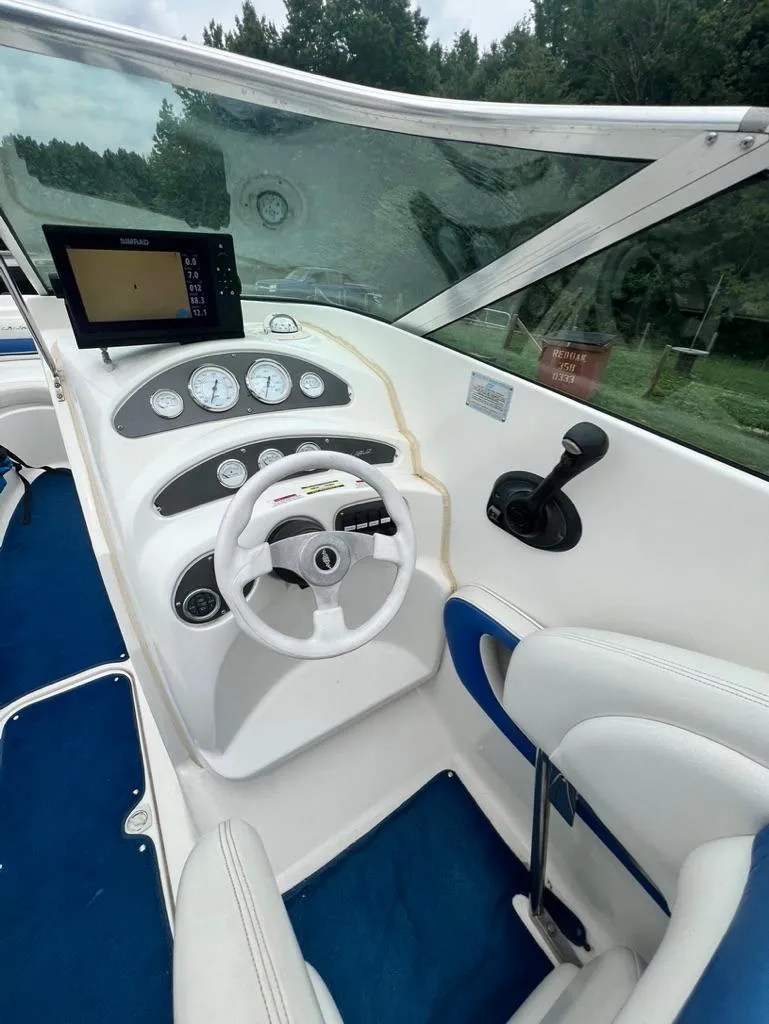 Slide: The Image of 2001 Wellcraft 260 Excalibur Sport boat cockpit with steering wheel and navigation system. - 3