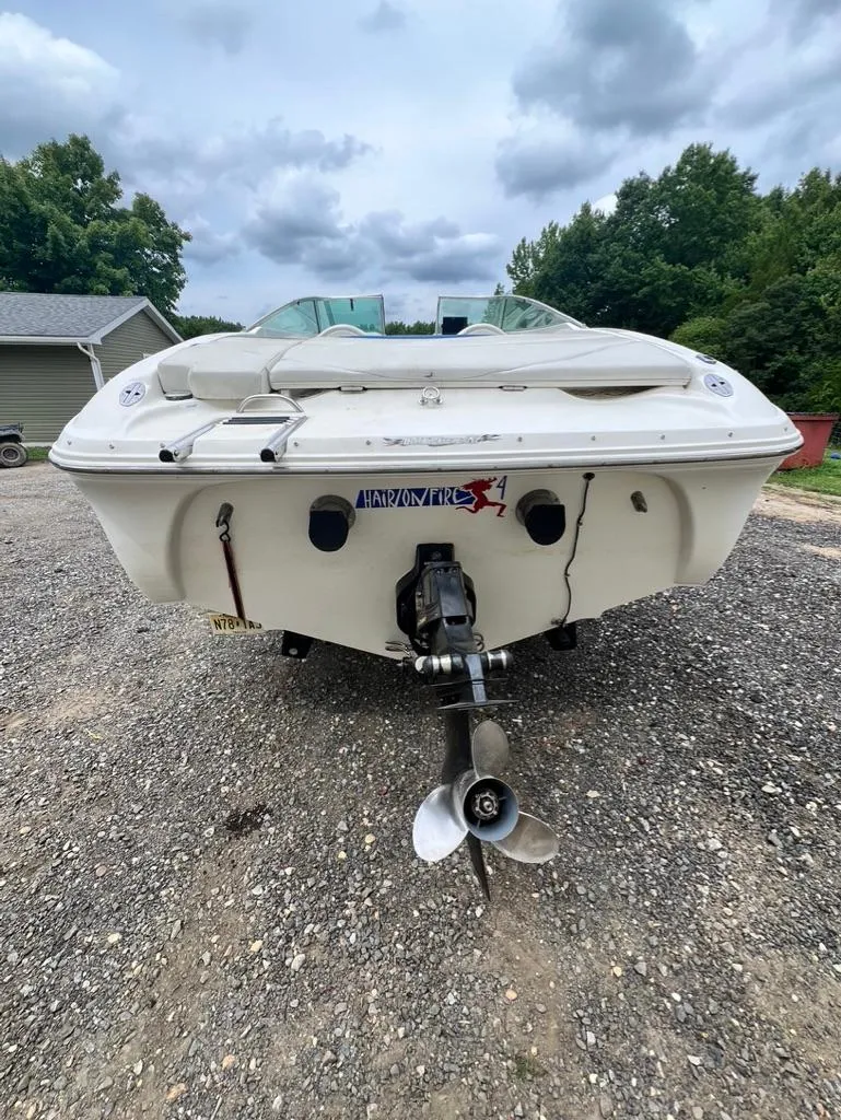 Slide: The Image of 2001 Wellcraft 260 Excalibur Sport boat, rear view, on gravel lot. - 9