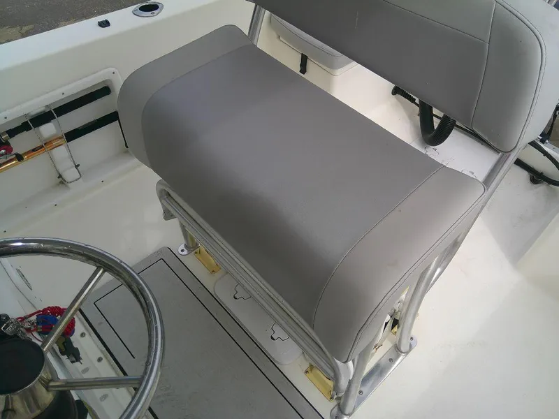 Slide: The Image of KenCraft Challenger 21 2020 boat interior with gray cushioned seating and steering wheel. - 13