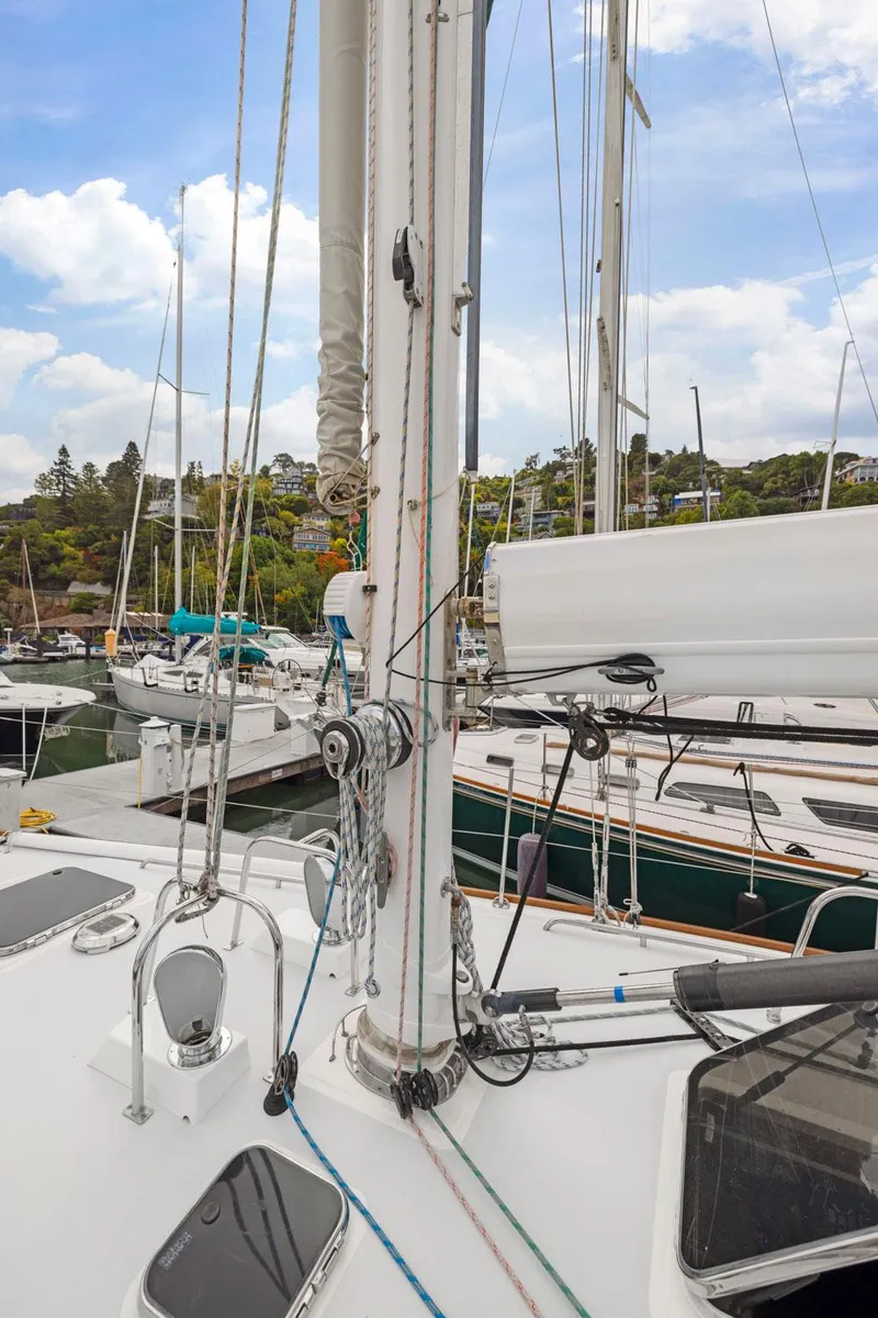 Slide: The Image of Sailboat deck view, Morris 486, 2005 model, docked in a marina under a partly cloudy sky. - 12