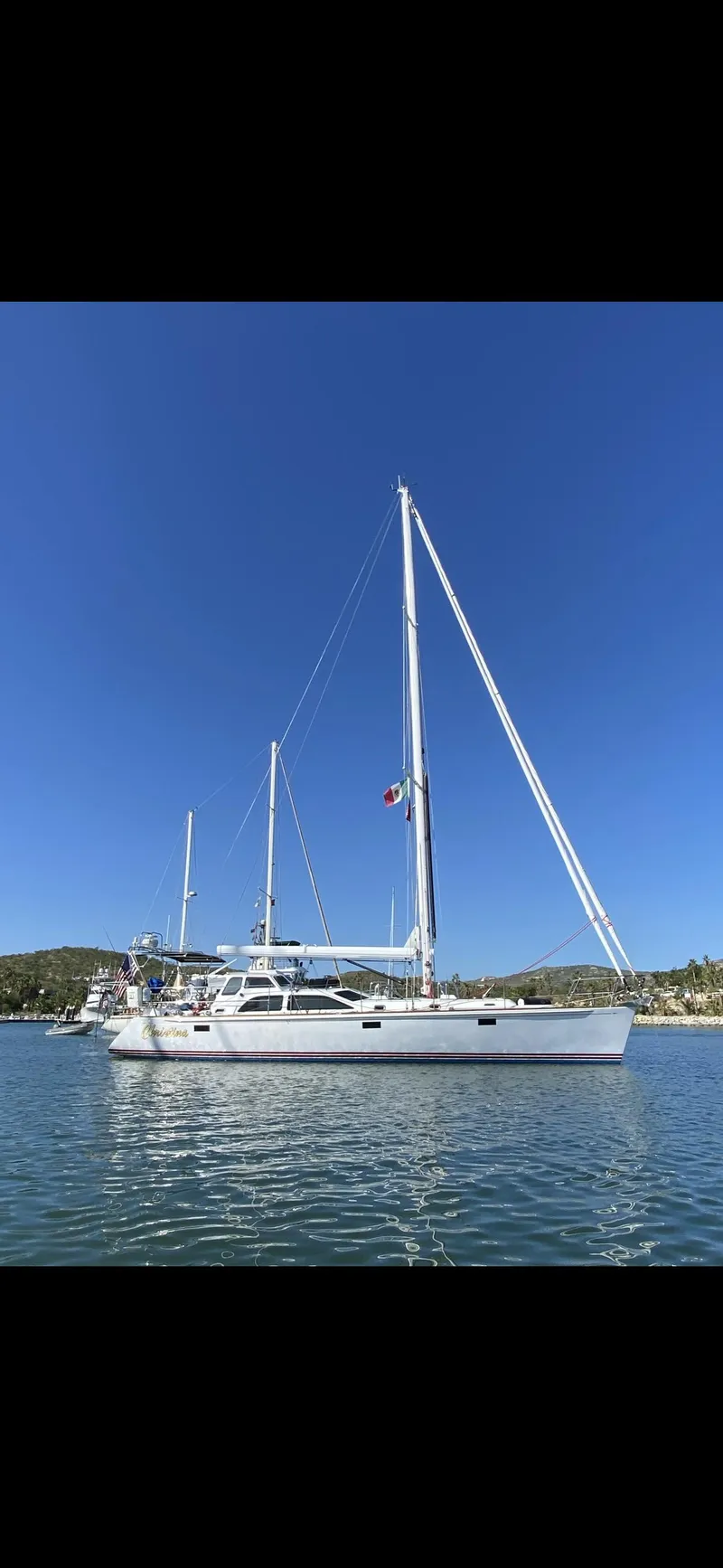 Slide: The Image of Sailing yacht Morris 486, 2005 model, on calm water under clear blue sky. - 2