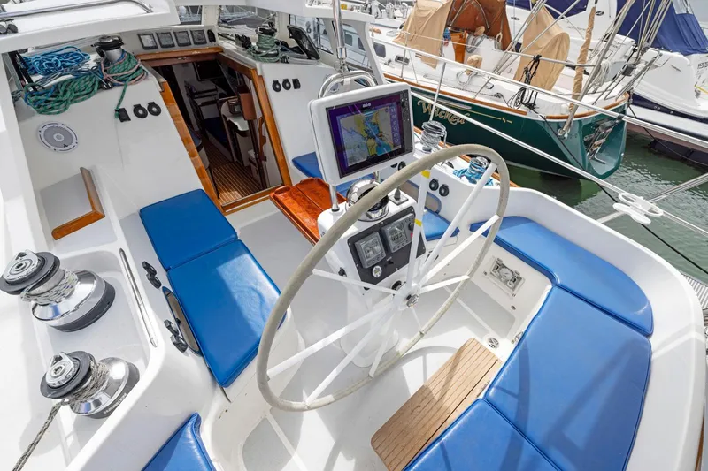 Slide: The Image of Cockpit of 2005 Morris 486 sailboat with blue seating and navigation equipment. - 27