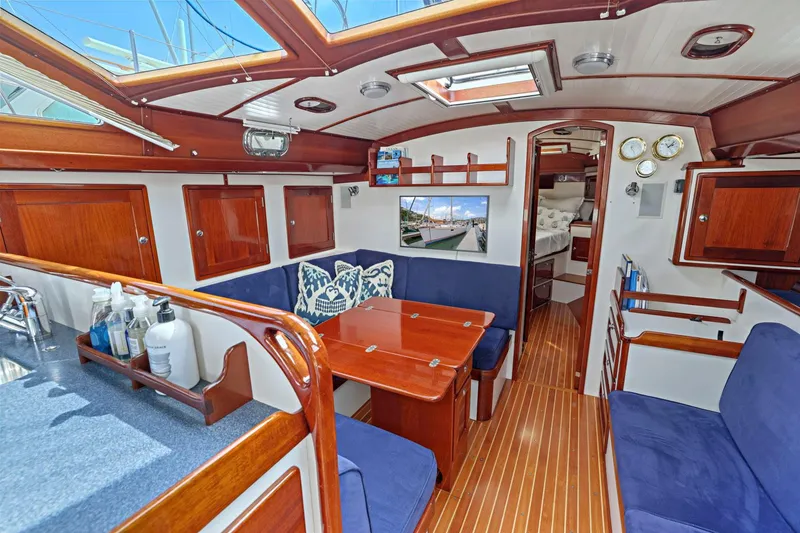 Slide: The Image of Luxurious 2005 Morris 486 yacht interior with wooden finishes and blue seating. - 39
