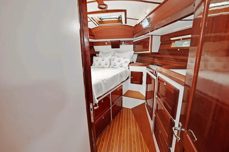 Slide: The Image of Luxurious wooden interior of a 2005 Morris 486 yacht cabin with cozy bedding. - 42