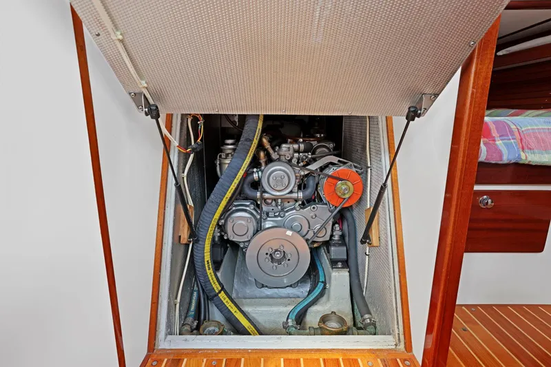 Slide: The Image of Engine compartment of a 2005 Morris 486, showcasing mechanical components and belts. - 46