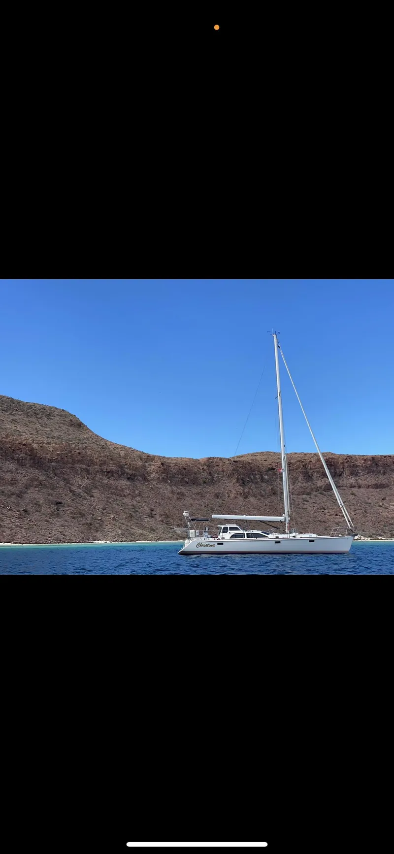 Slide: The Image of Sailboat on calm water with rocky hills, clear blue sky; Morris 486, 2005 model. - 47