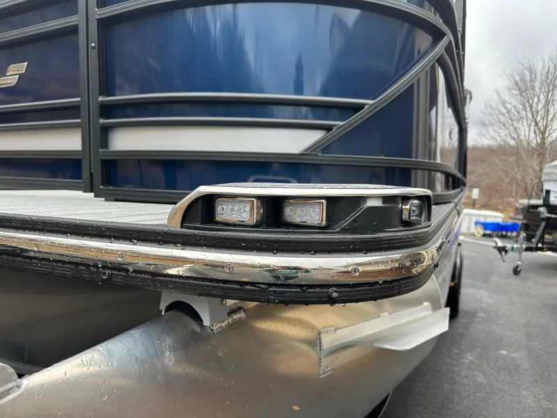 Slide: The Image of Close-up of 2024 Starcraft MX 25 R pontoon boat's front LED lights. - 1