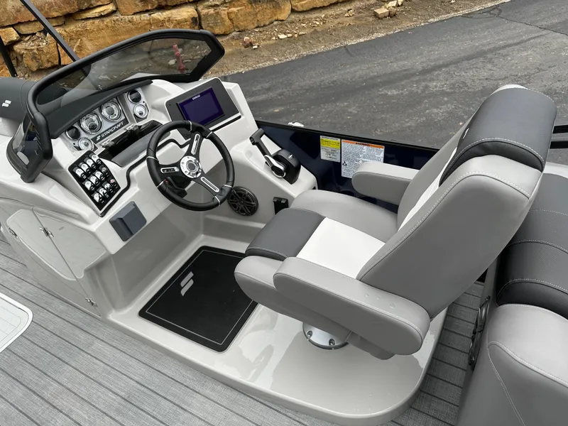 Slide: The Image of 2024 Starcraft MX 25 R boat cockpit with modern controls and comfortable seating. - 11