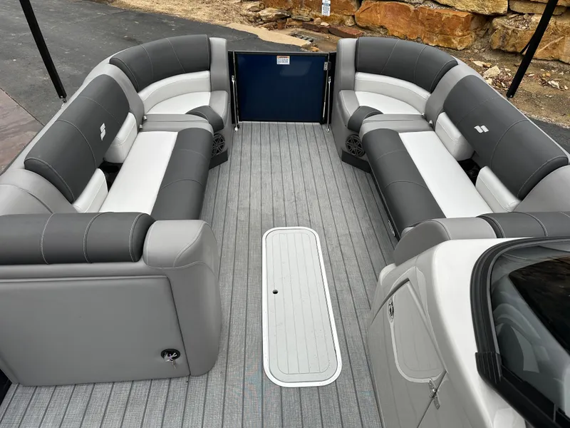 Slide: The Image of 2024 Starcraft MX 25 R boat interior with gray and white seating. - 13