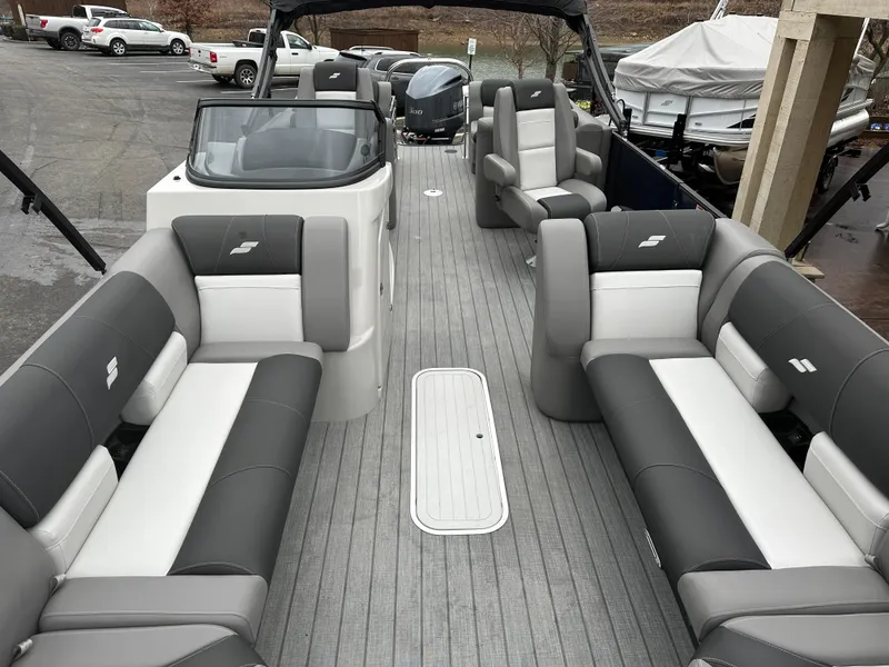 Slide: The Image of 2024 Starcraft MX 25 R pontoon boat interior with gray and white seating. - 14