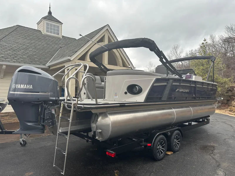 Slide: The Image of 2024 Starcraft MX 25 R pontoon boat with Yamaha outboard motor on trailer. - 2