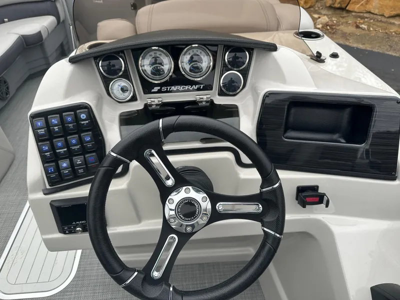 Slide: The Image of 2024 Starcraft MX 25 R boat dashboard with steering wheel and control panel. - 7