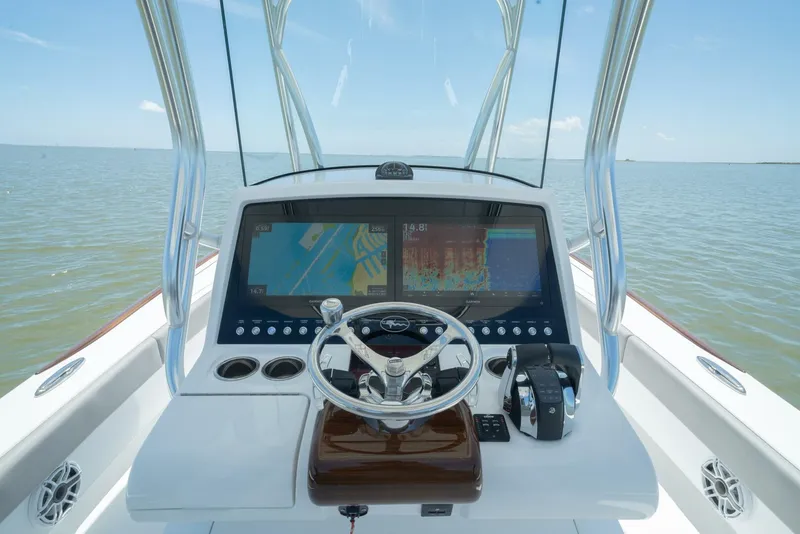 Slide: The Image of 2024 Valhalla Boatworks V-28 helm station with dual displays and steering wheel. - 2