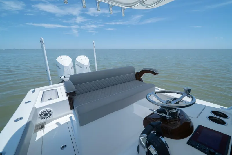 Slide: The Image of 2024 Valhalla Boatworks V-28 helm station with dual outboard engines on open water. - 23