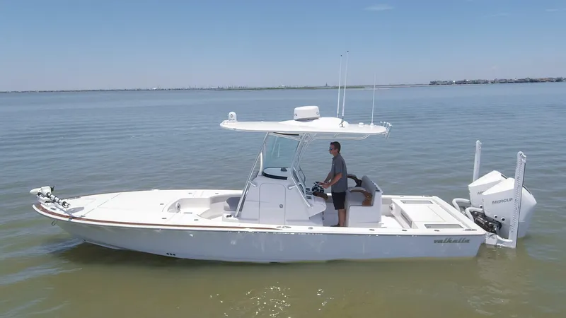 Slide: The Image of 2024 Valhalla Boatworks V-28 on calm water with a person at the helm. - 36
