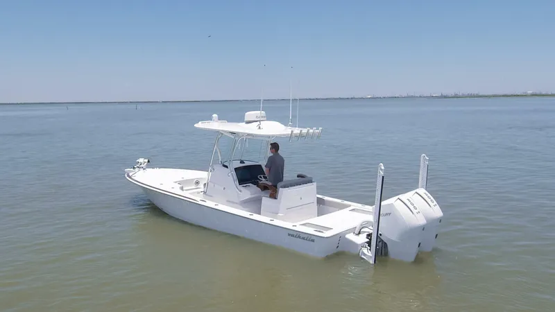 Slide: The Image of 2024 Valhalla Boatworks V-28 on calm waters with a person at the helm. - 40