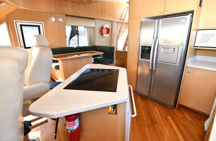 Slide: The Image of Interior of 1997 Forbes Cooper 74 Pilothouse yacht with modern kitchen and seating area. - 11