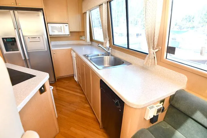 Slide: The Image of Kitchen interior of 1997 Forbes Cooper 74 Pilothouse yacht with modern appliances. - 12