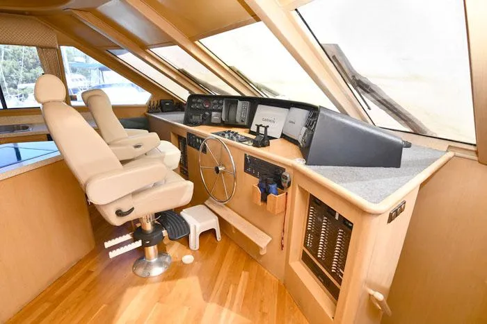 Slide: The Image of 1997 Forbes Cooper 74 Pilothouse interior with helm, steering wheel, and navigation equipment. - 15