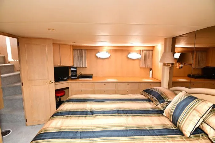 Slide: The Image of Luxurious bedroom interior of 1997 Forbes Cooper 74 Pilothouse yacht with striped bedding. - 18