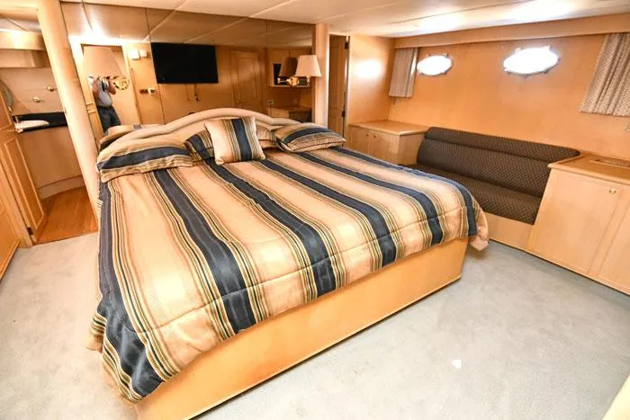 Slide: The Image of Luxurious bedroom interior of 1997 Forbes Cooper 74 Pilothouse yacht with striped bedding. - 19