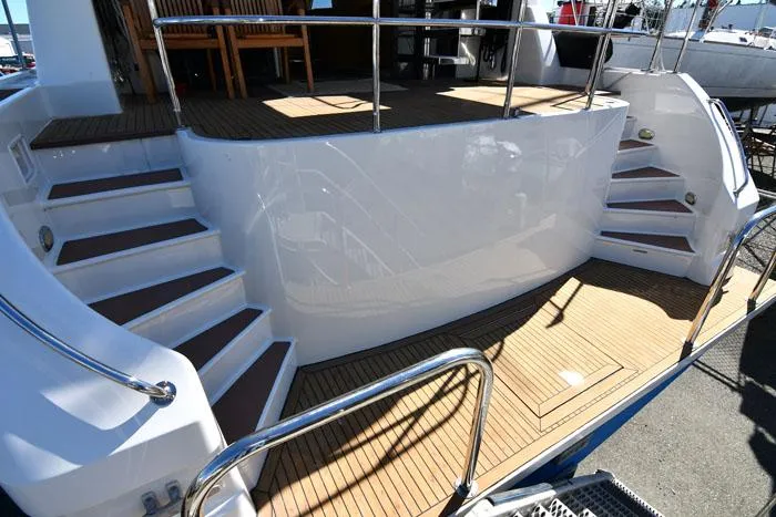 Slide: The Image of Staircase and deck of 1997 Forbes Cooper 74 Pilothouse yacht, featuring sleek design and wood finish. - 2