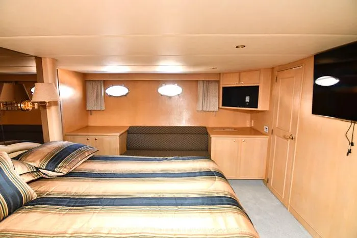 Slide: The Image of Luxurious bedroom interior of 1997 Forbes Cooper 74 Pilothouse yacht with striped bedding. - 20
