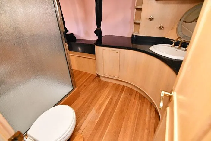 Slide: The Image of Luxurious bathroom in 1997 Forbes Cooper 74 Pilothouse yacht with wooden flooring and modern fixtures. - 22