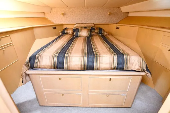 Slide: The Image of Luxurious bedroom interior of 1997 Forbes Cooper 74 Pilothouse yacht with striped bedding. - 27