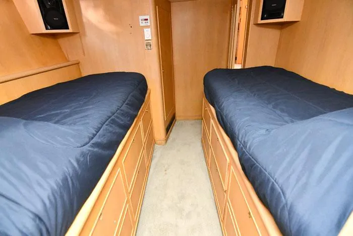 Slide: The Image of Twin beds in 1997 Forbes Cooper 74 Pilothouse cabin with blue bedding. - 29