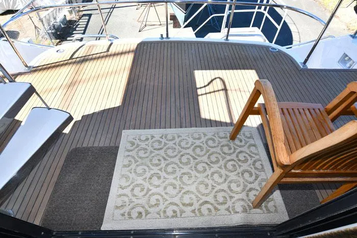 Slide: The Image of Deck of 1997 Forbes Cooper 74 Pilothouse with wooden chair and patterned rug. - 3
