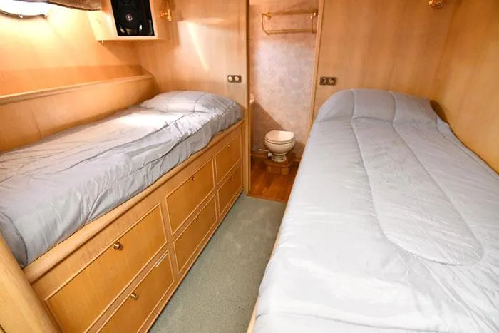 Slide: The Image of 1997 Forbes Cooper 74 Pilothouse cabin with twin beds and wooden storage drawers. - 32