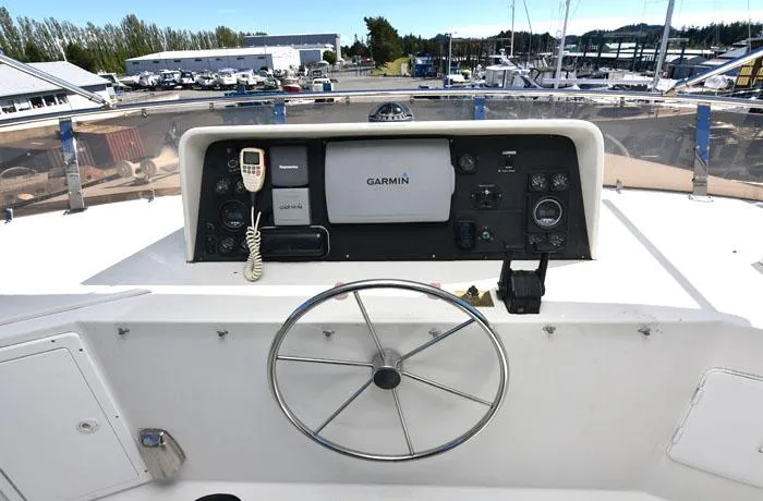 Slide: The Image of Pilothouse helm of 1997 Forbes Cooper 74, featuring Garmin navigation and communication equipment. - 34