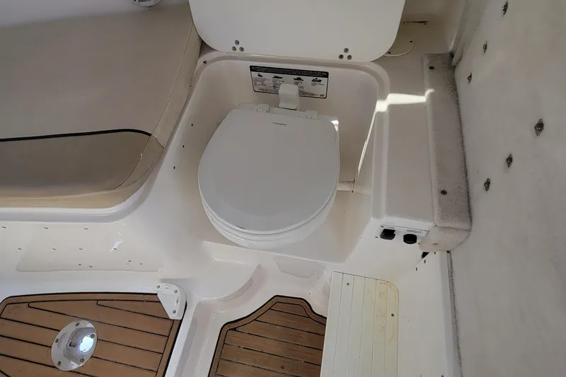 Slide: The Image of Sea Fox 256 Voyager 2018 boat interior with marine toilet and seating. - 12