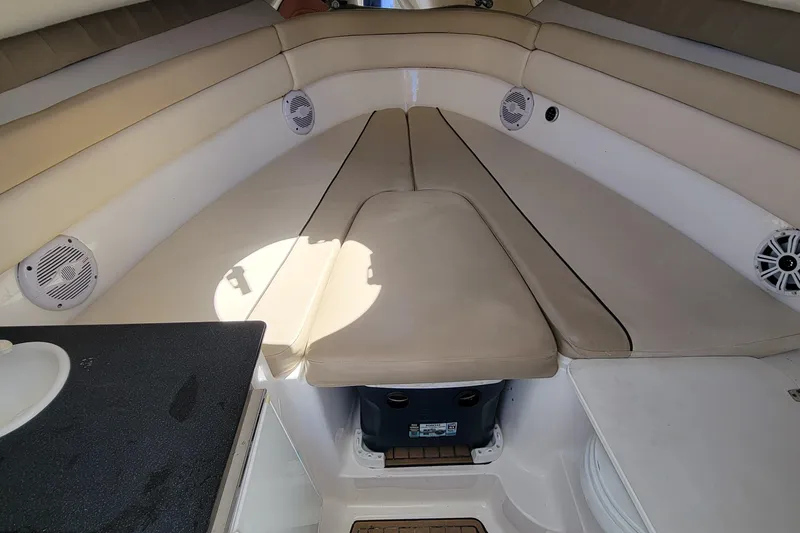 Slide: The Image of Interior seating area of a 2018 Sea Fox 256 Voyager boat with beige cushions. - 14