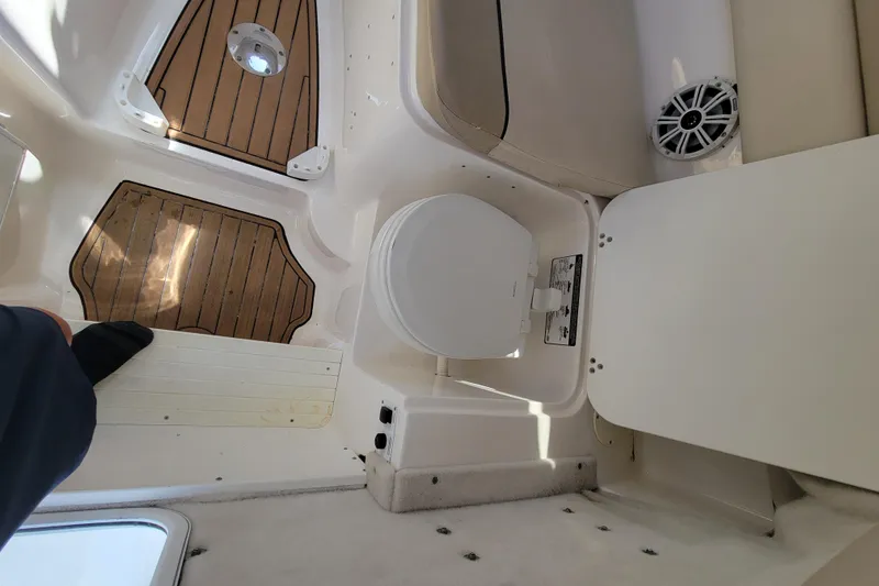 Slide: The Image of 2018 Sea Fox 256 Voyager boat interior with toilet and wooden flooring. - 15