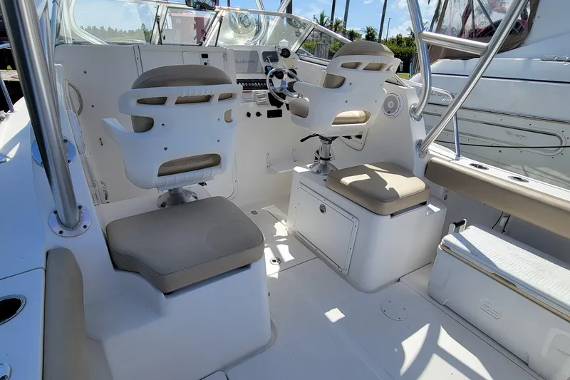 Slide: The Image of 2018 Sea Fox 256 Voyager boat interior with dual captain chairs and control console. - 17